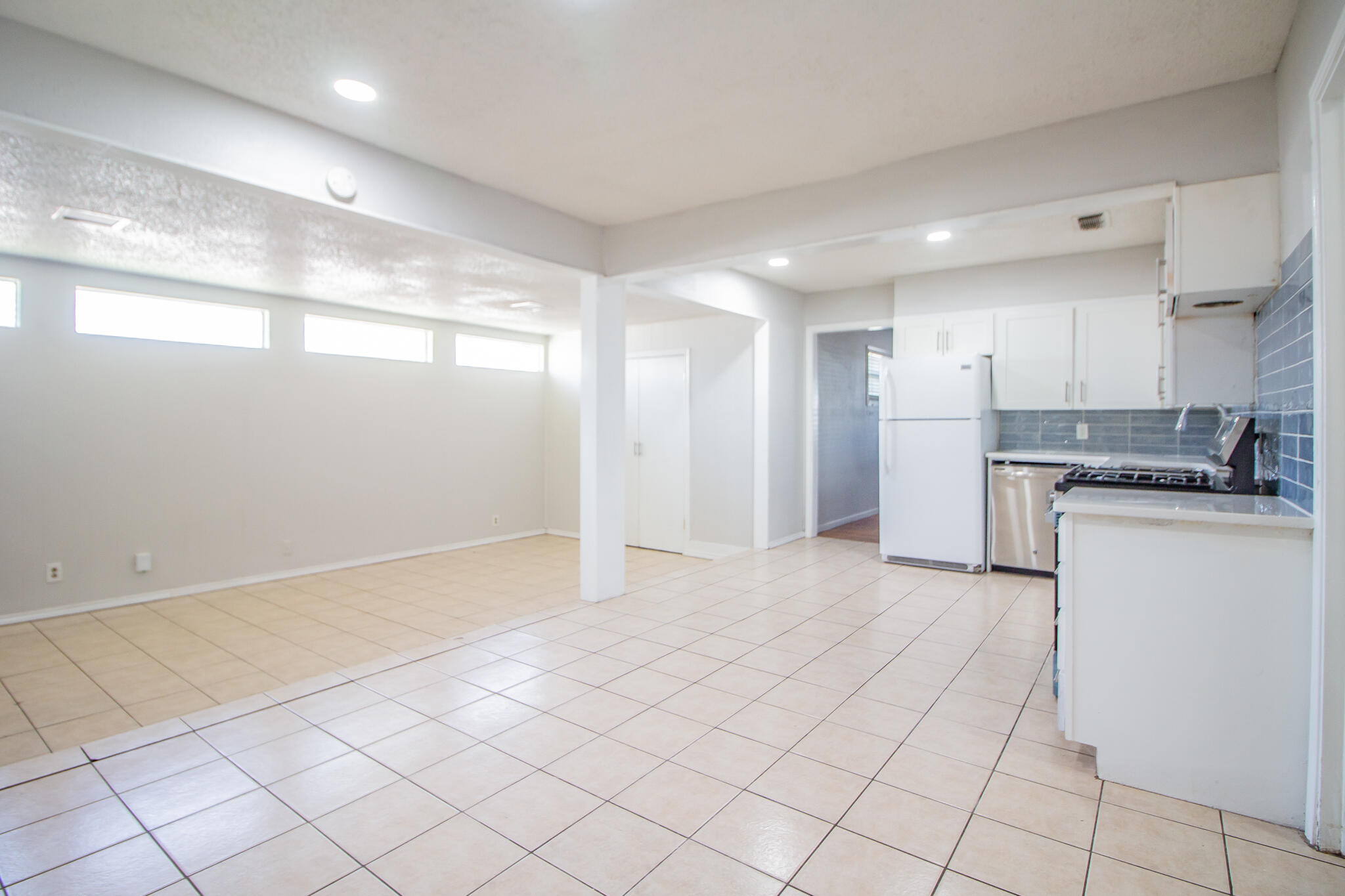 3721 31st Street Lubbock, TX 79410 - Photo 7 of 21 a view of a kitchen with a sink and a refrigerator