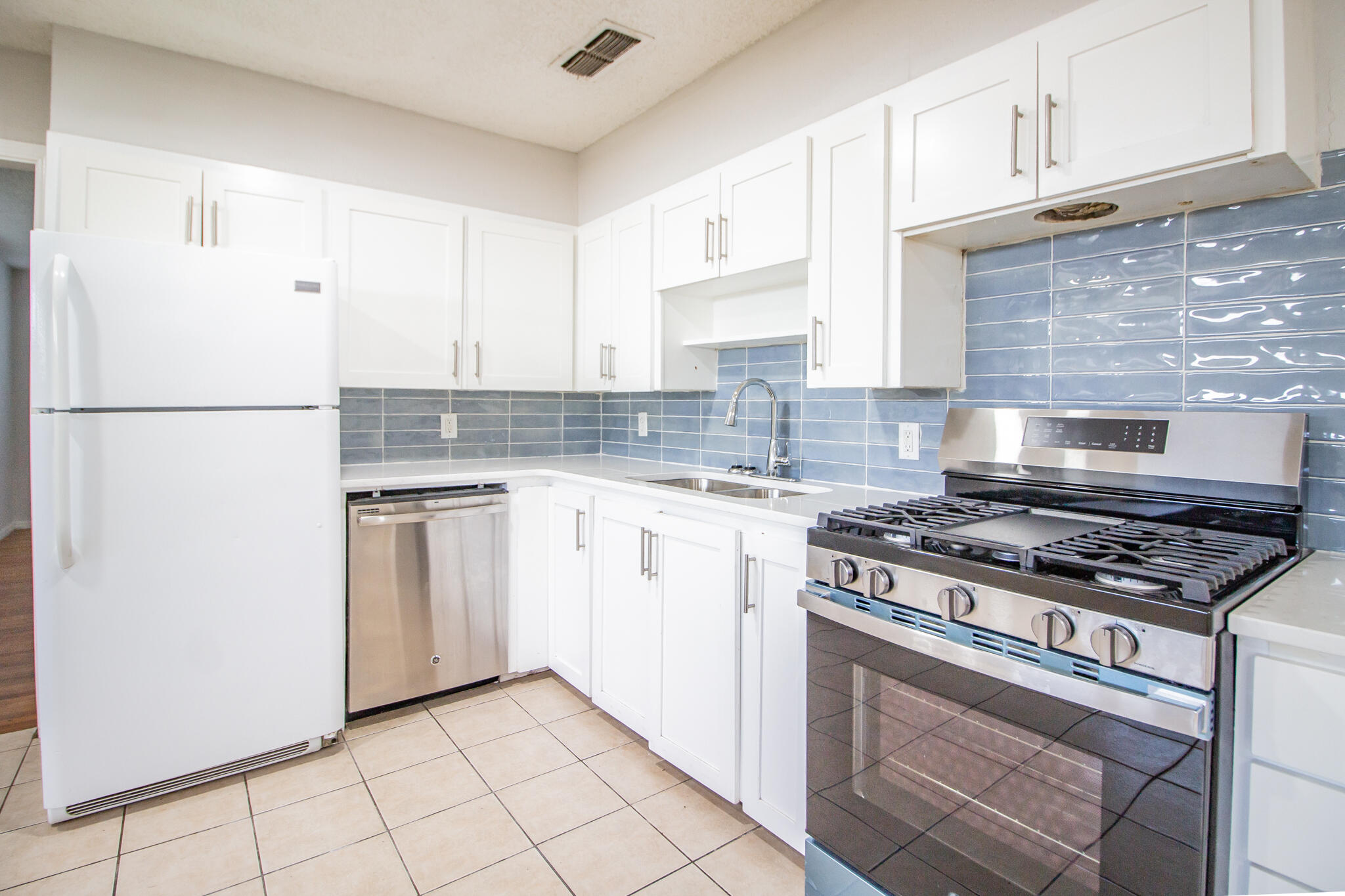 3721 31st Street Lubbock, TX 79410 - Photo 8 of 21 a kitchen with cabinets appliances a sink and a counter top space