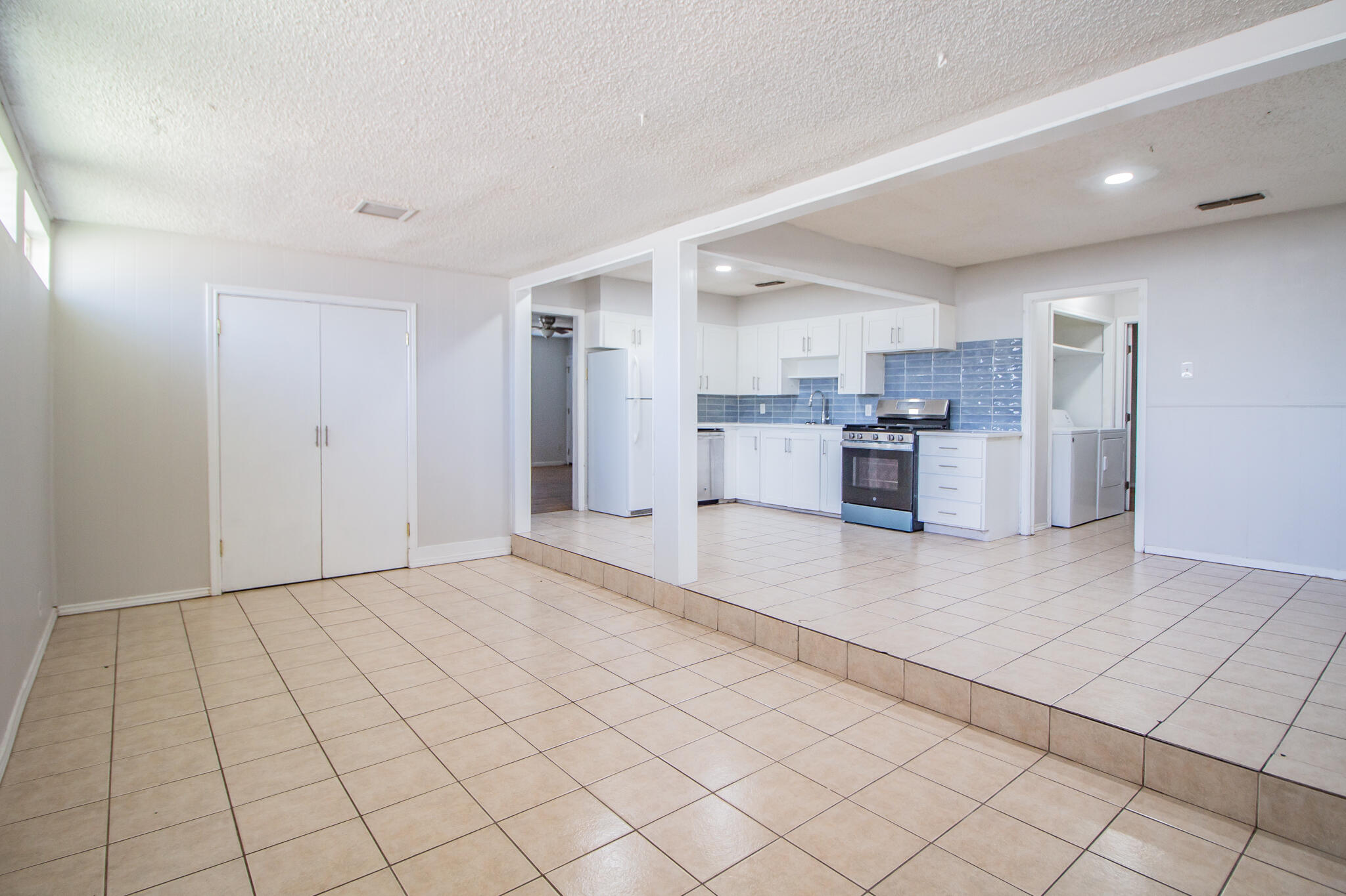 3721 31st Street Lubbock, TX 79410 - Photo 10 of 21 a view of a kitchen with a sink and an open refrigerator
