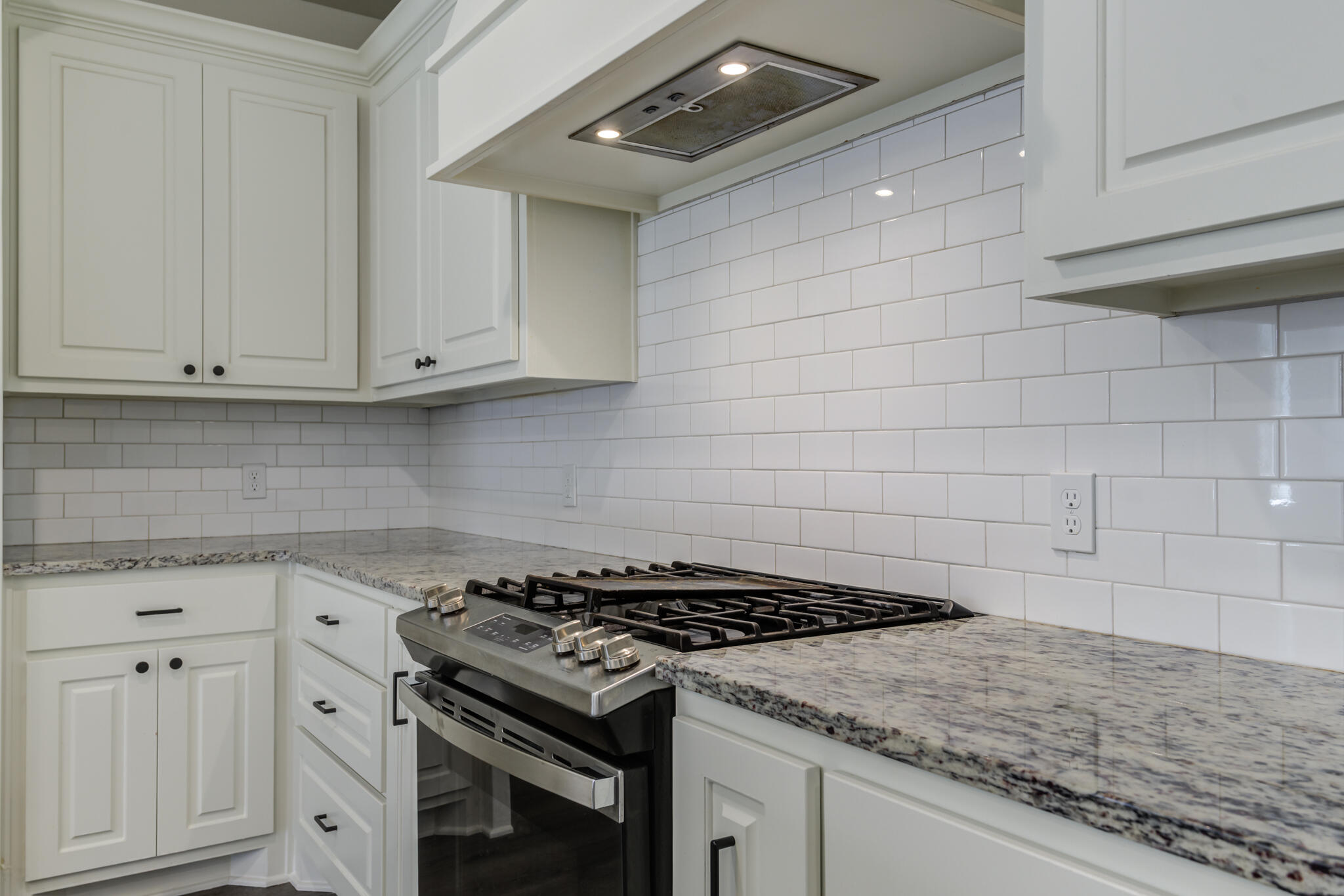 6904 55th Street Lubbock, TX 79407 - Photo 11 of 47 a stove top oven sitting inside of a kitchen