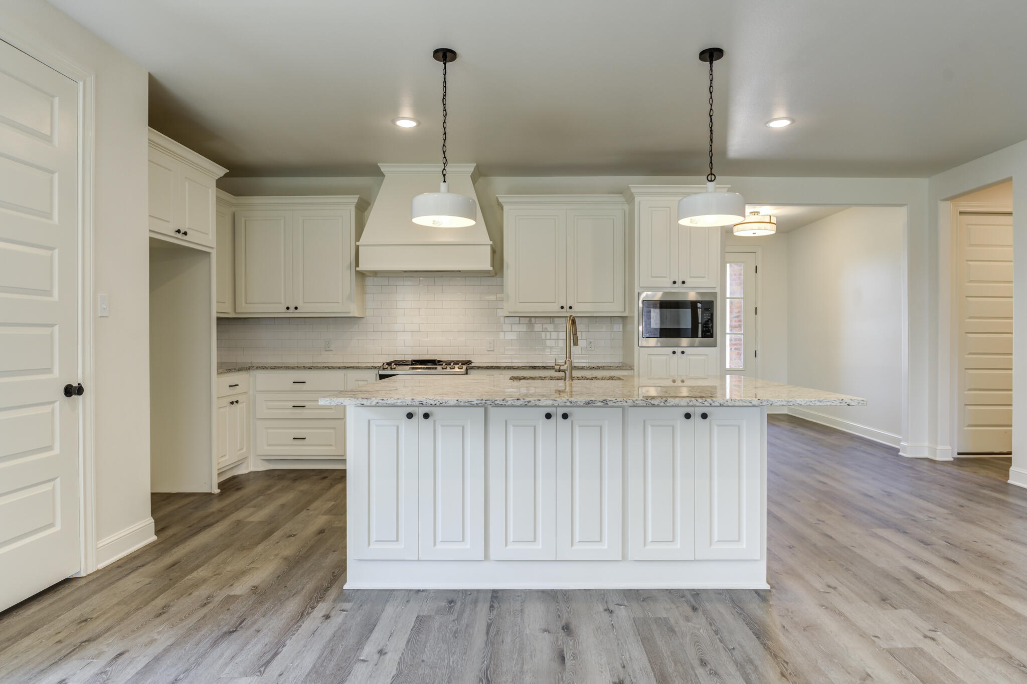 6904 55th Street Lubbock, TX 79407 - Photo 14 of 47 a view of kitchen with granite countertop cabinets and wooden floor