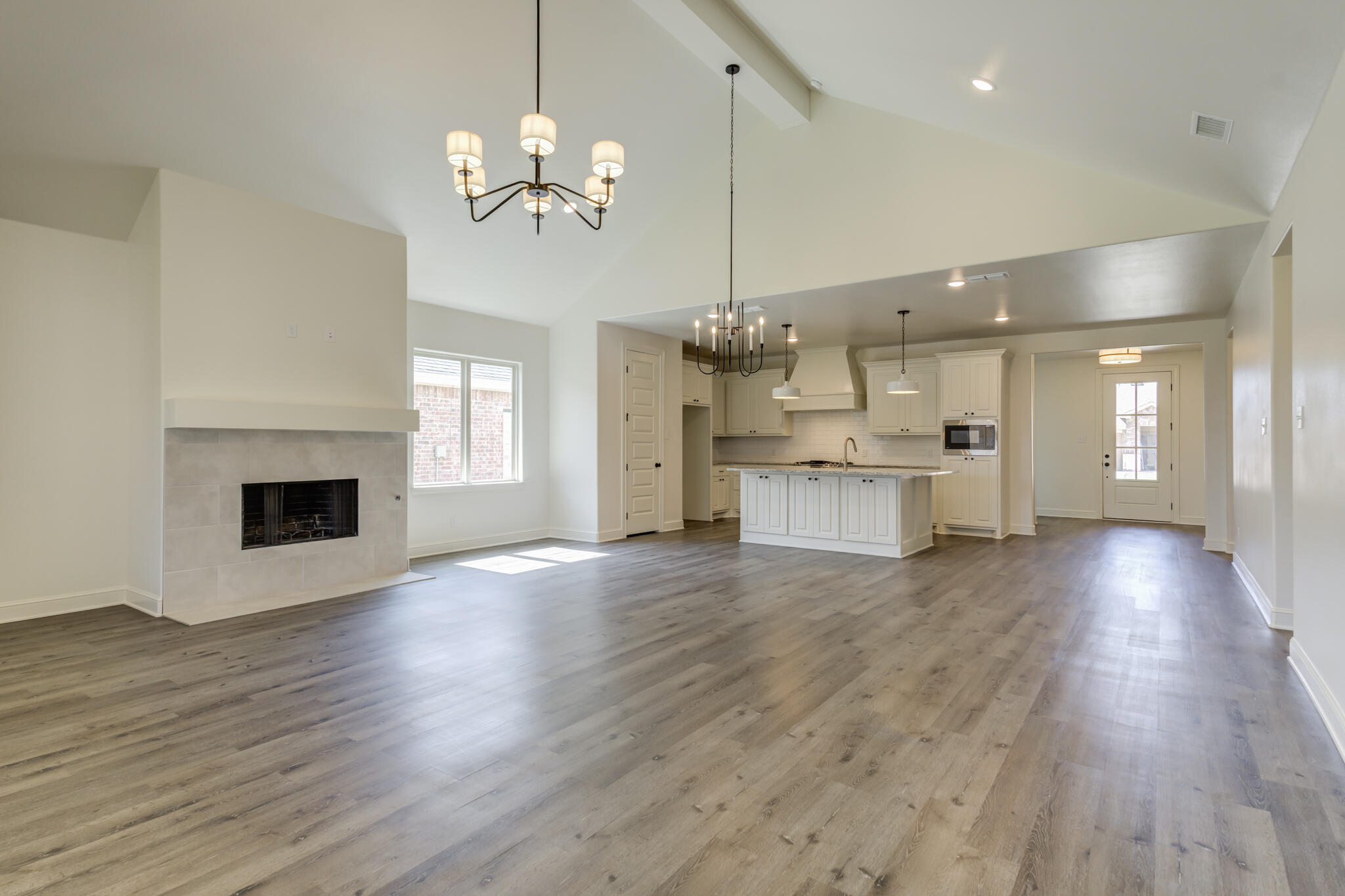 6904 55th Street Lubbock, TX 79407 - Photo 21 of 47 a view of a big room with wooden floor and kitchen