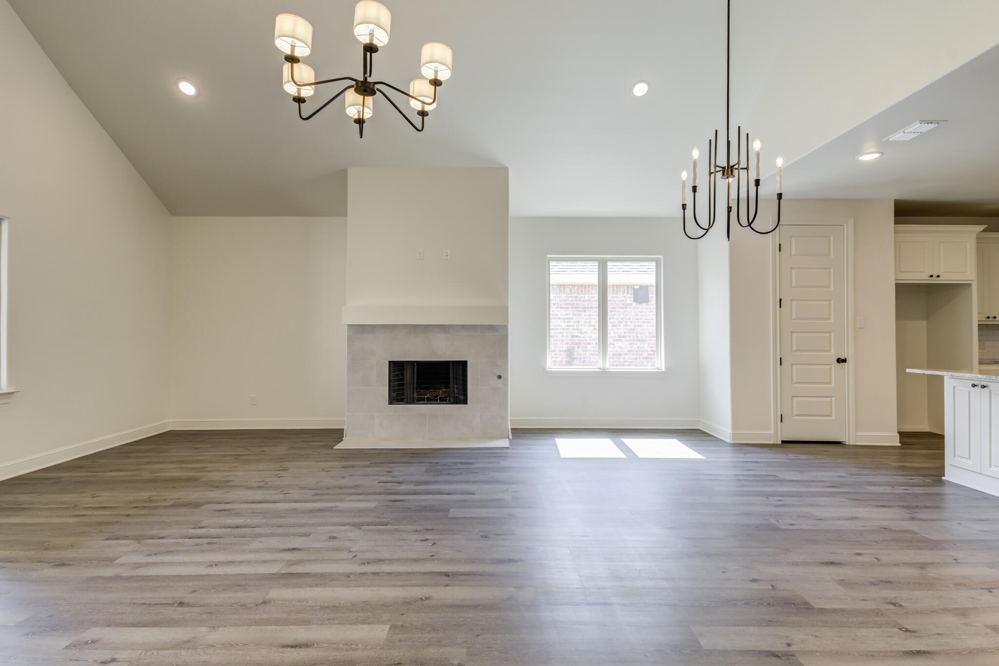 6904 55th Street Lubbock, TX 79407 - Photo 22 of 47 a view of an empty room with a window and wooden floor