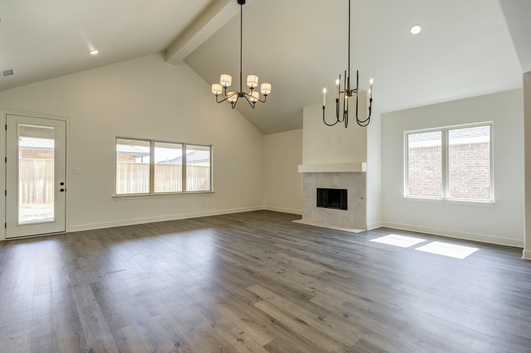 6904 55th Street Lubbock, TX 79407 - Photo 24 of 47 a view of an empty room with a fireplace and wooden floor