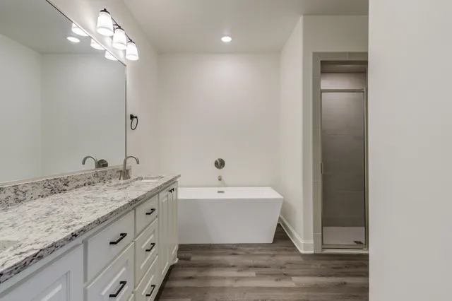 a bathroom with a bathtub and shower