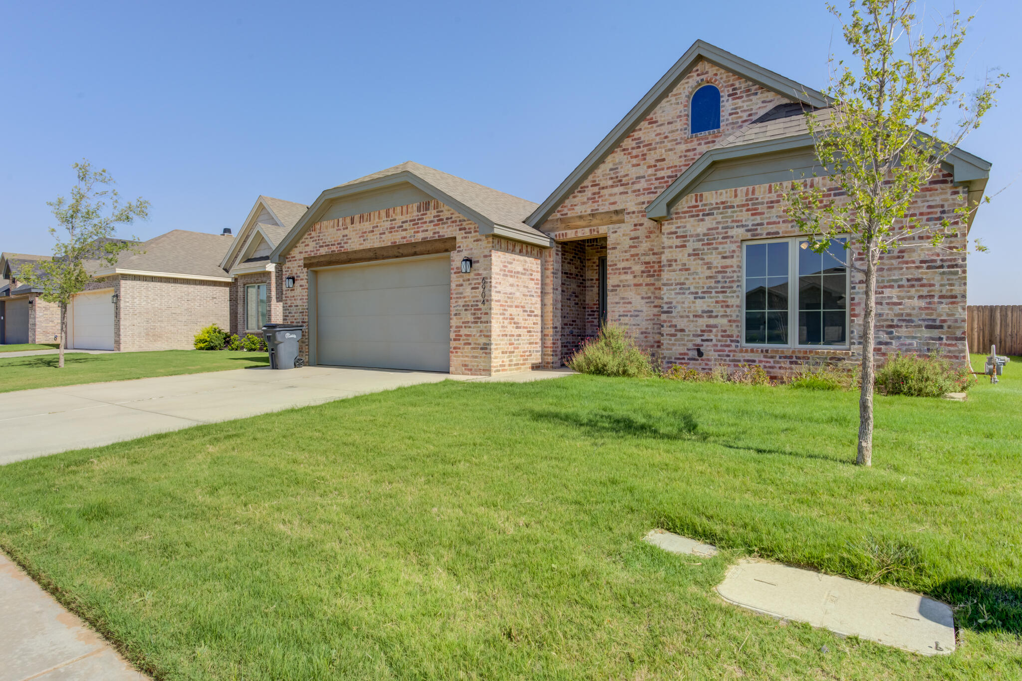 6904 55th Street Lubbock, TX 79407 - Photo 3 of 47 a front view of a house with garden