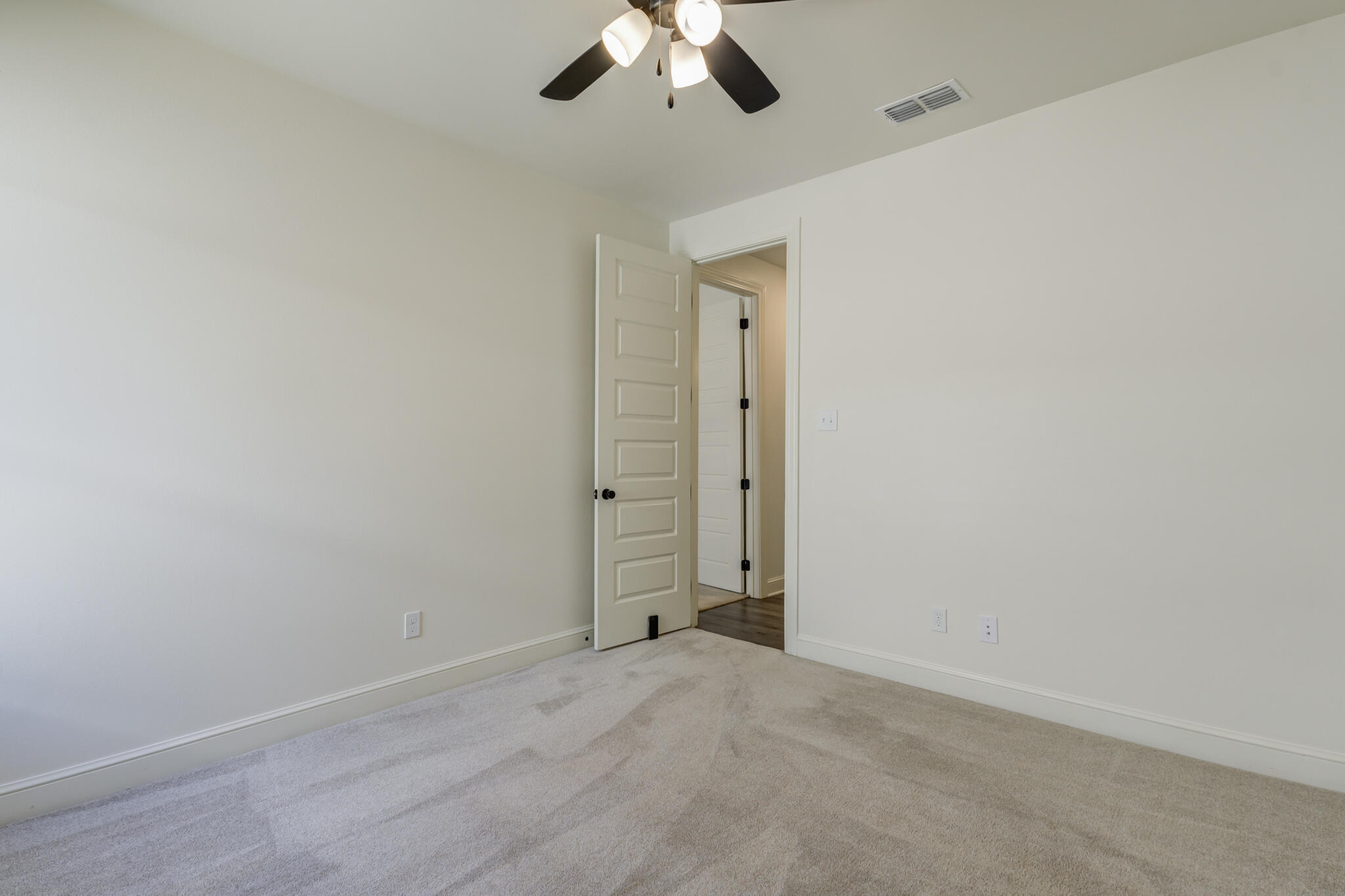 6904 55th Street Lubbock, TX 79407 - Photo 41 of 47 an empty room with a chandelier fan and windows