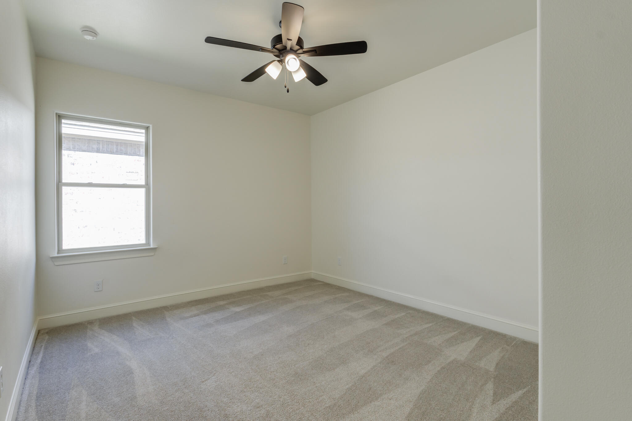 6904 55th Street Lubbock, TX 79407 - Photo 42 of 47 an empty room with a window and a fan