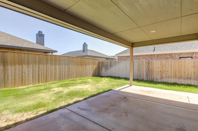 a view of a house with backyard and a garden