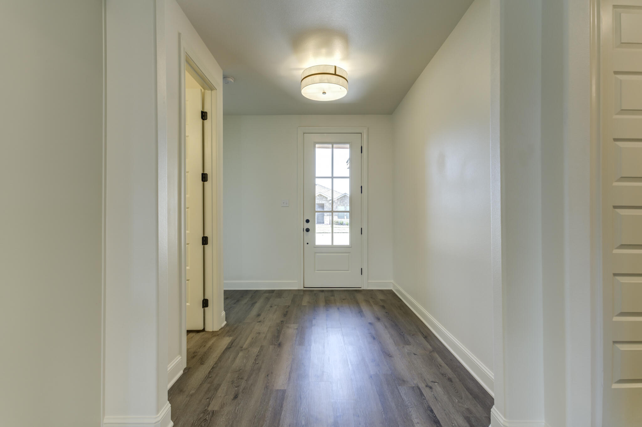 6904 55th Street Lubbock, TX 79407 - Photo 6 of 47 an empty room with wooden floor and windows