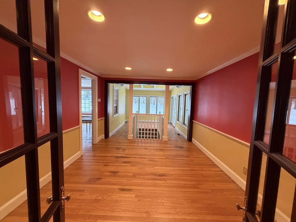 31 Fells Road Winchester, MA 01890 - Photo 7 of 22 a view of an empty room with wooden floor and stairs