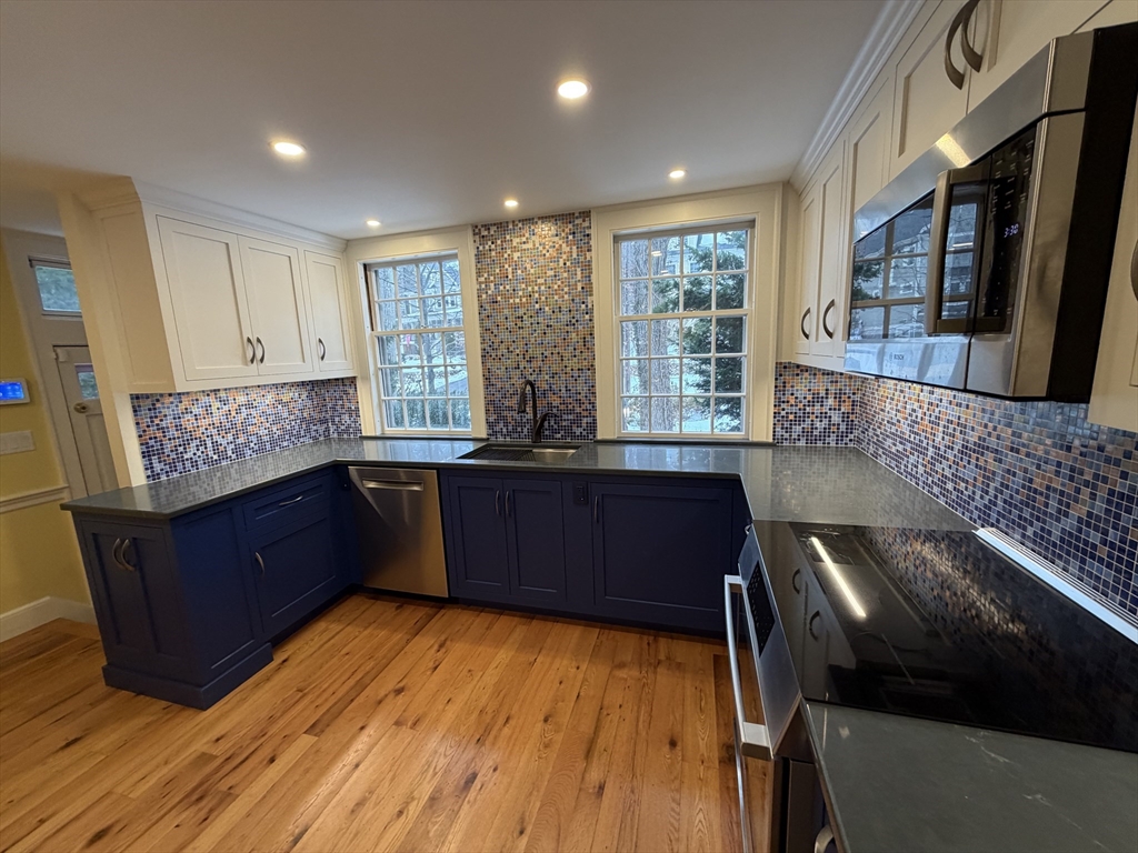 31 Fells Road Winchester, MA 01890 - Photo 10 of 22 a kitchen with stainless steel appliances granite countertop a stove a sink and a large window