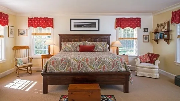 a bedroom with furniture and a fireplace