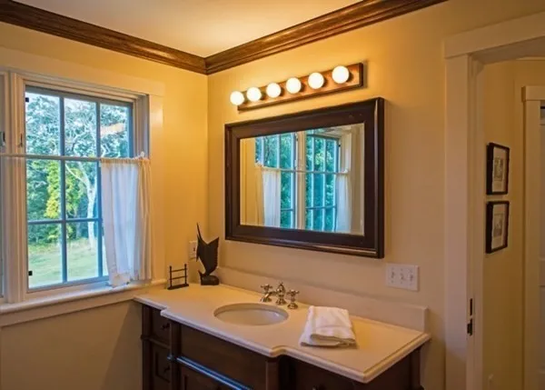 a bathroom with a sink a mirror and a window