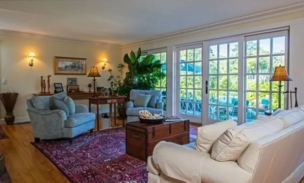 a living room with furniture and a floor to ceiling window