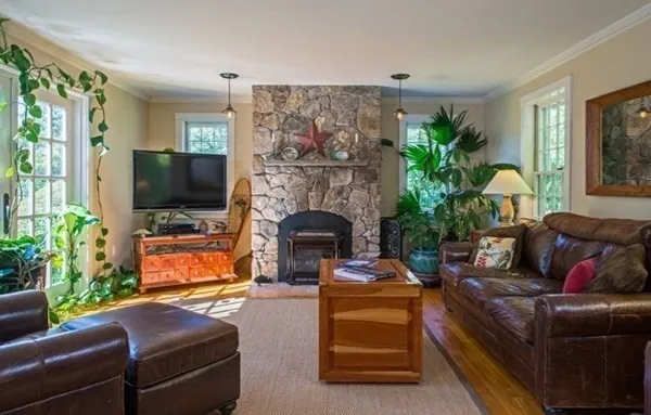 a living room with furniture a flat screen tv and a fireplace