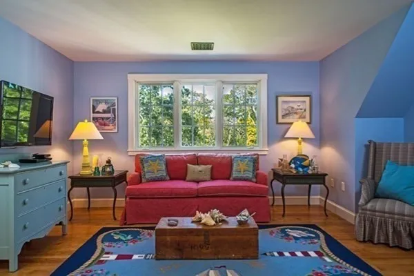 a living room with furniture and a lamp