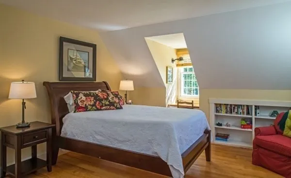 a bedroom with a bed furniture and a window