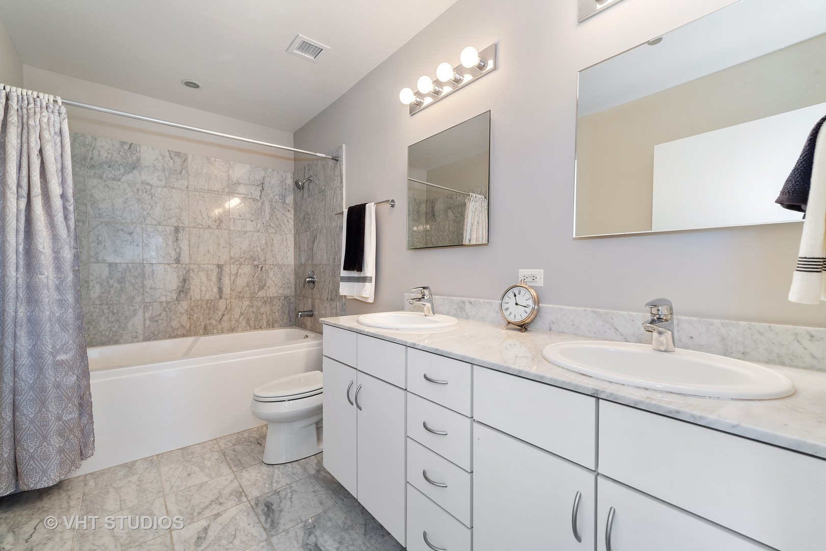 860 West Blackhawk Street, Unit 2803 Chicago, IL 60642 - Photo 12 of 17 a bathroom with a double vanity sink toilet mirror and bathtub