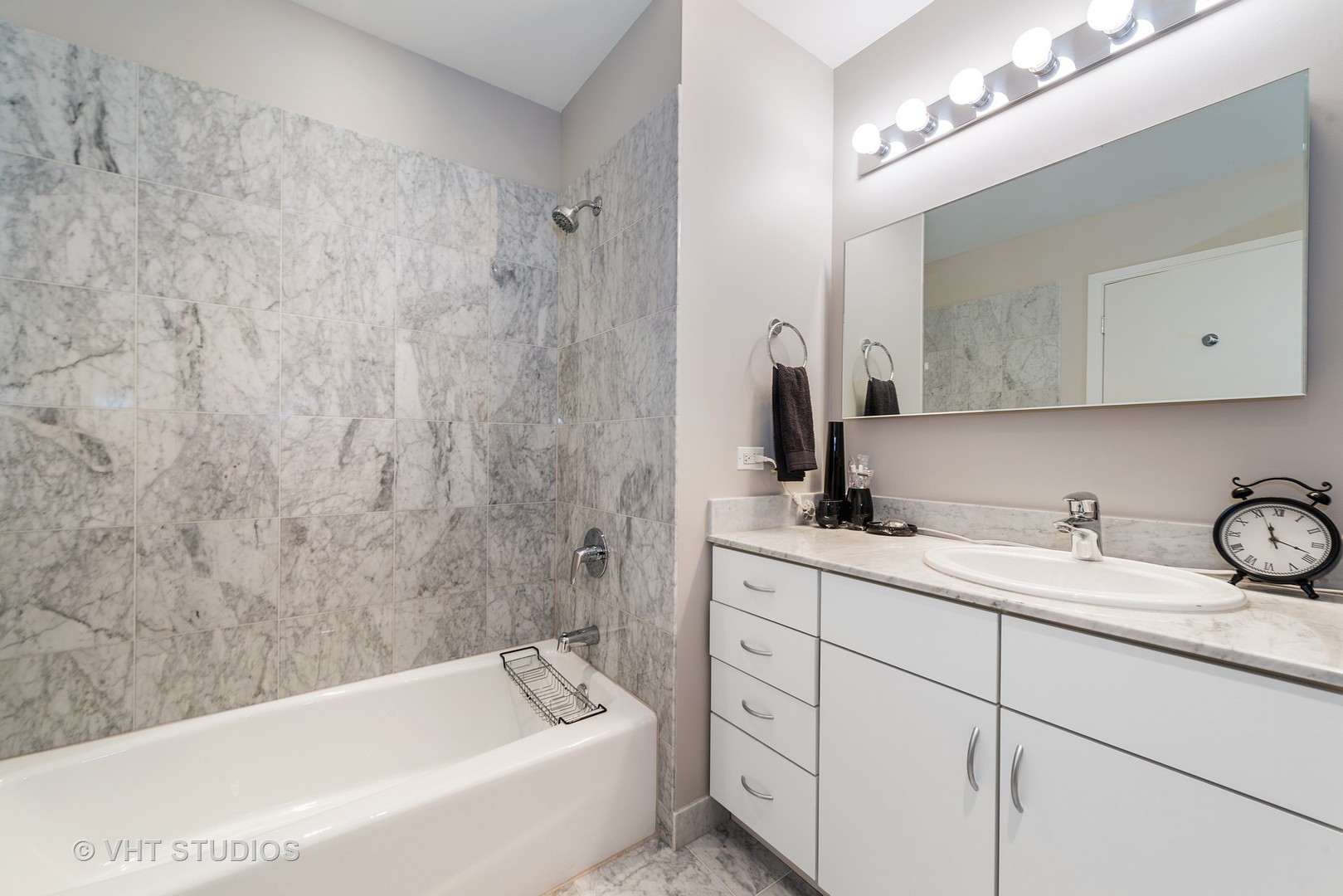 860 West Blackhawk Street, Unit 2803 Chicago, IL 60642 - Photo 14 of 17 a bathroom with a sink a bathtub a mirror and vanity