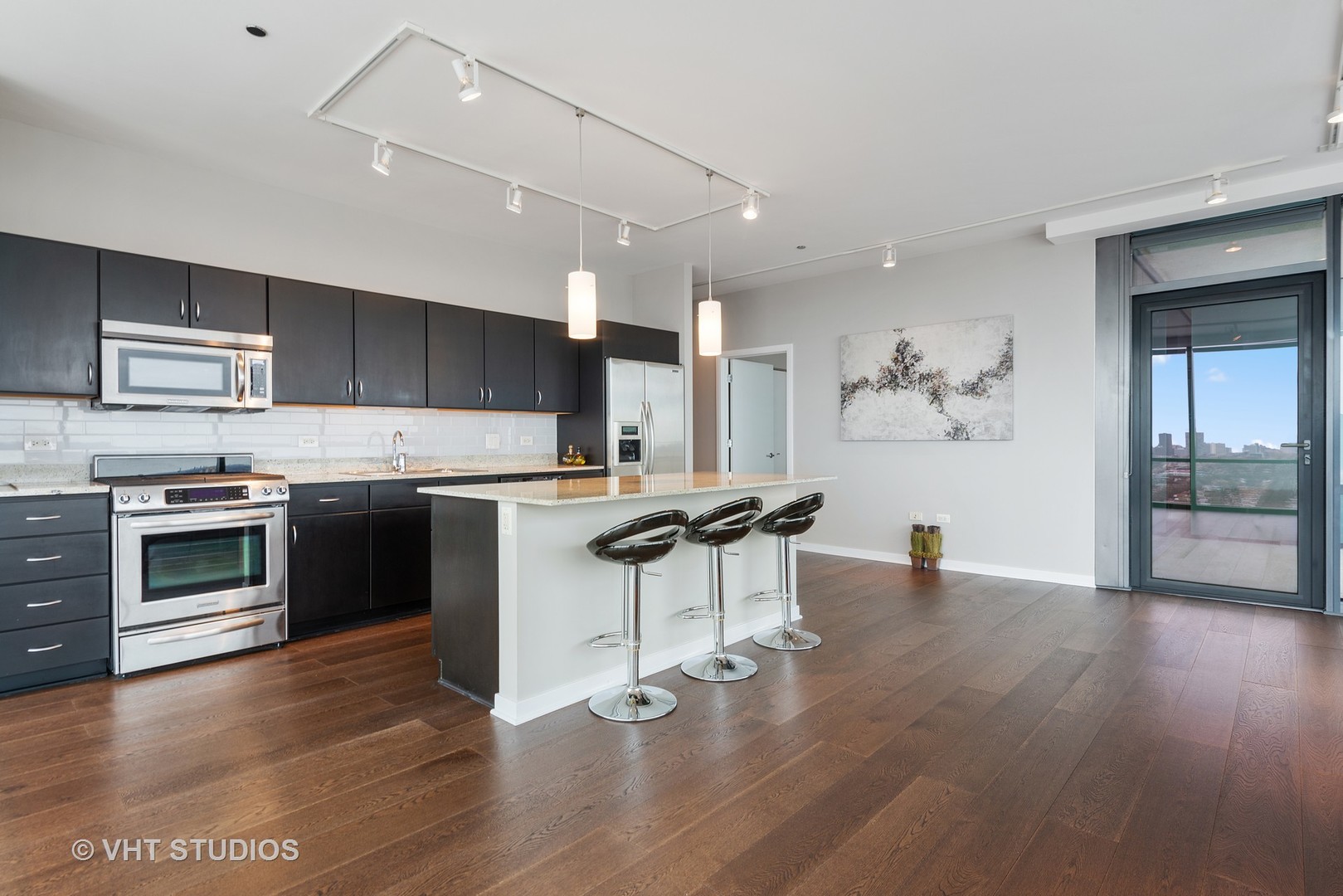 860 West Blackhawk Street, Unit 2803 Chicago, IL 60642 - Photo 7 of 17 a kitchen with stainless steel appliances a stove a sink and a microwave