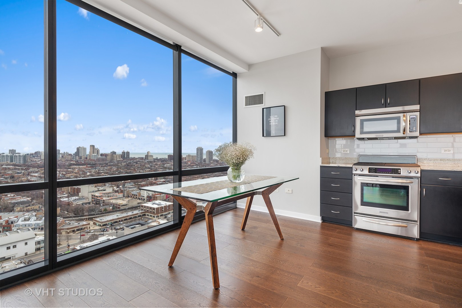 860 West Blackhawk Street, Unit 2803 Chicago, IL 60642 - Photo 9 of 17 a very nice looking living room with a large window a table and chairs