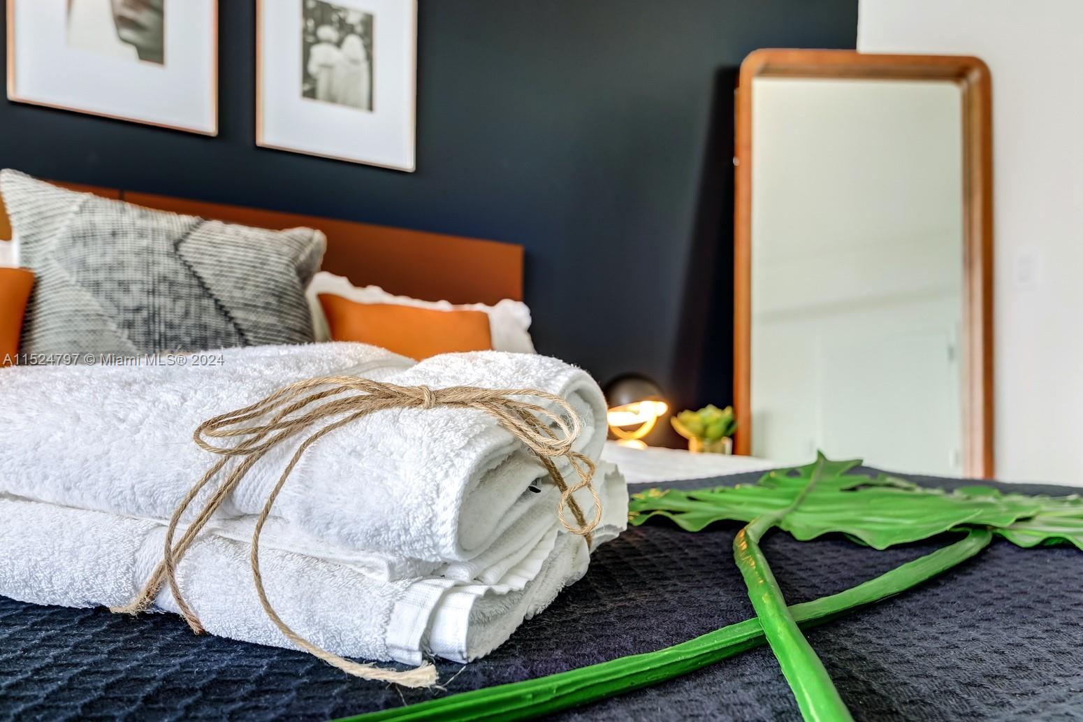 2889 McFarlane Road, Unit 2017 Coconut Grove, FL 33133 - Photo 14 of 19 a bed sitting in a bedroom next to a window with yard