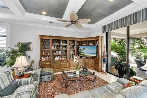 a living room with furniture and a floor to ceiling window