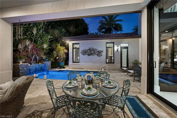 a view of a dining room with furniture a rug and wooden floor