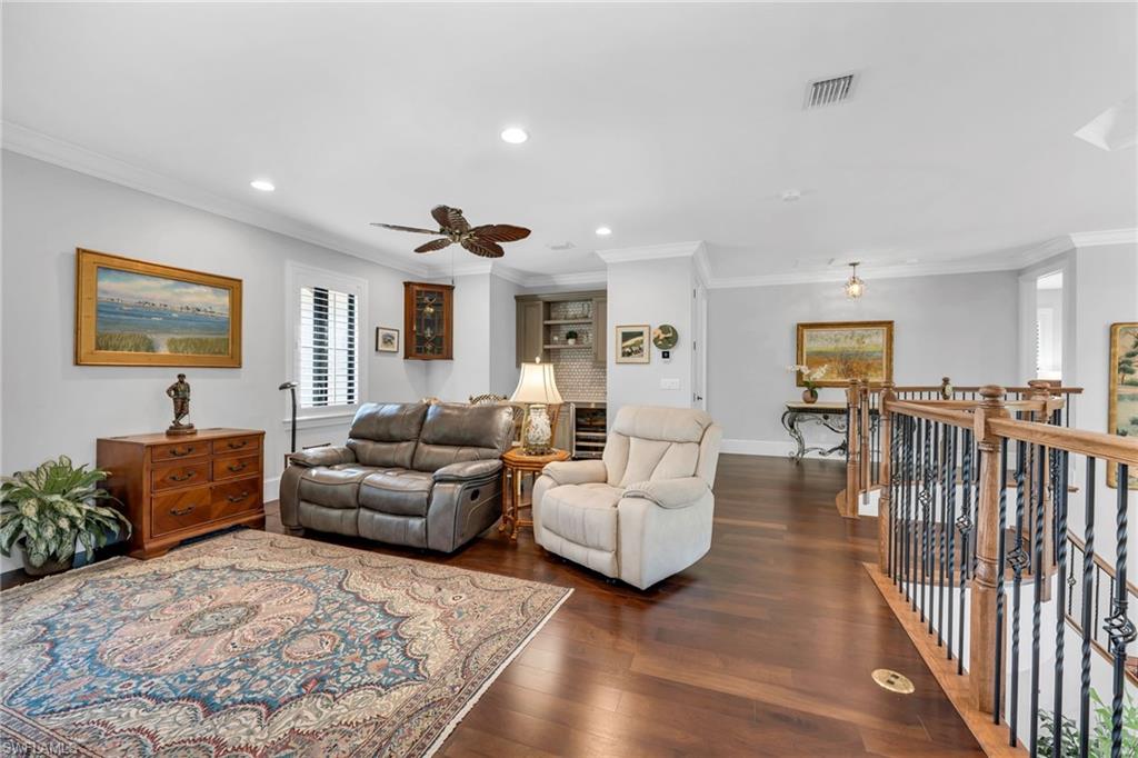 2331 Traditions Court Naples, FL 34105 - Photo 26 of 50 The loft has a bar with beverage refrigerator and this area can be made into a 5th bedroom or play area.
