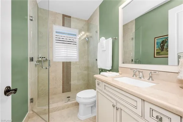 a bedroom with a bed a couch and a window