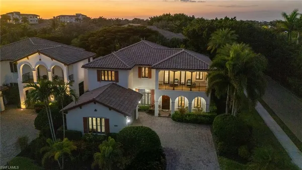 a view of patio with a table and chairs and potted plants