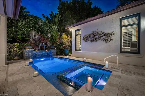 a view of swimming pool with seating space