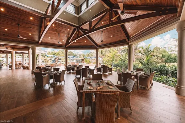a view of a patio with table and chairs and wooden floor