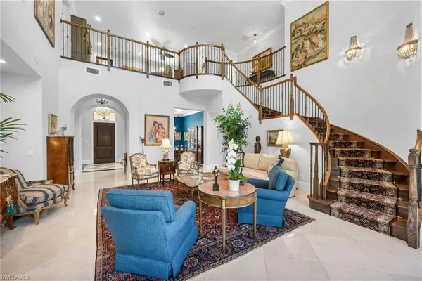 a living room with furniture and a chandelier