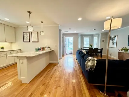 a large kitchen with stainless steel appliances granite countertop a stove a sink and a microwave