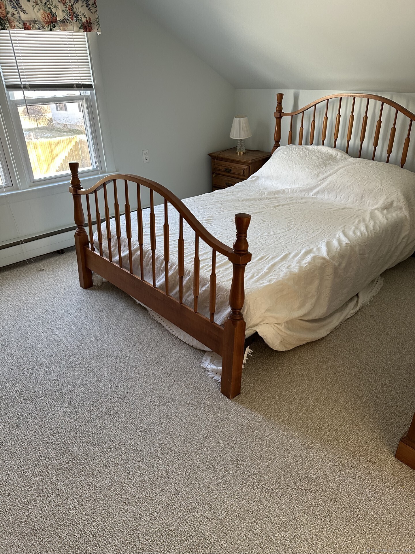 41 Harbor Avenue Madison, CT 06443 - Photo 16 of 27 a bed sitting in a bedroom next to a window