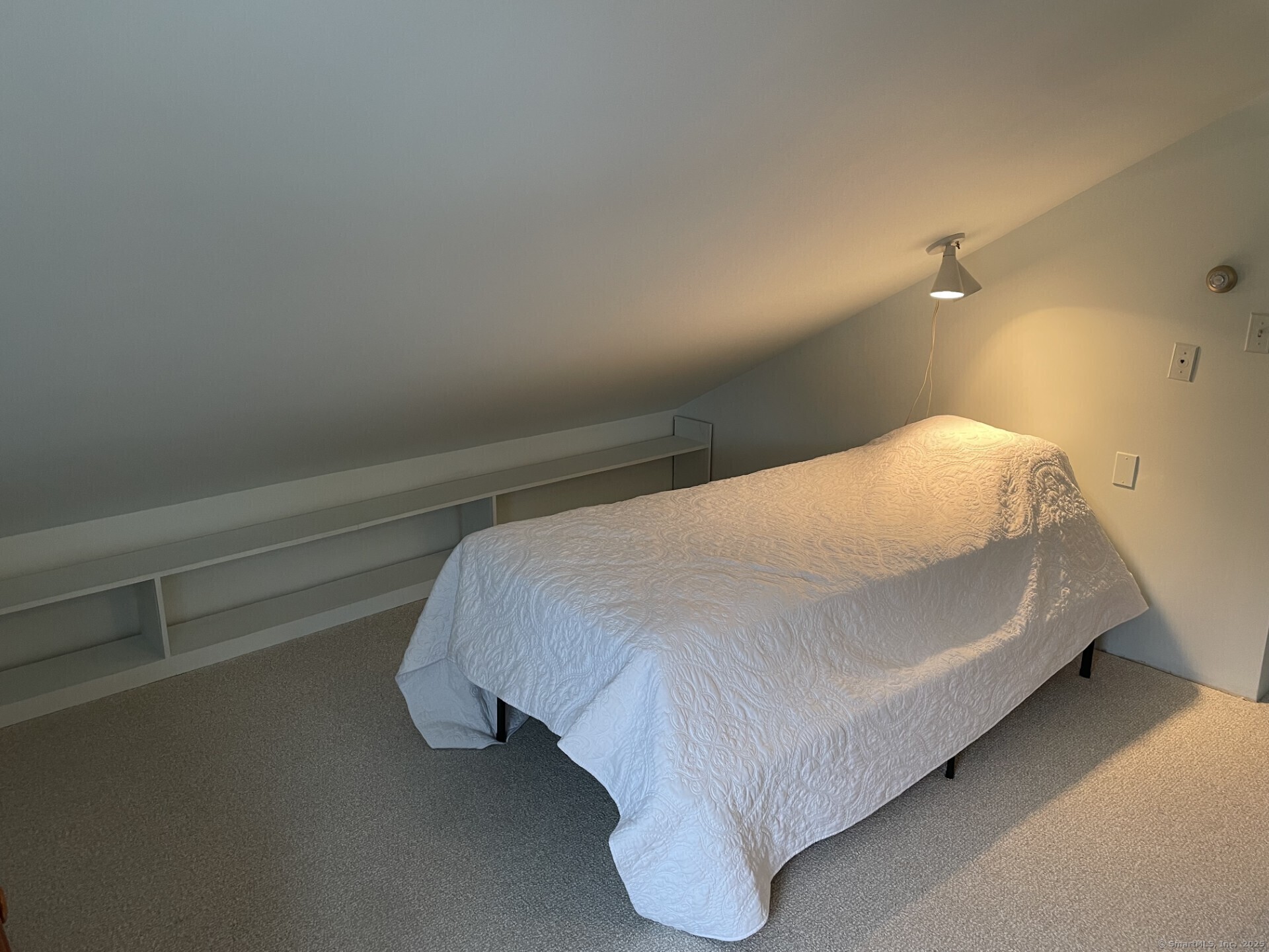 41 Harbor Avenue Madison, CT 06443 - Photo 18 of 27 a bed sitting in a bedroom next to a window