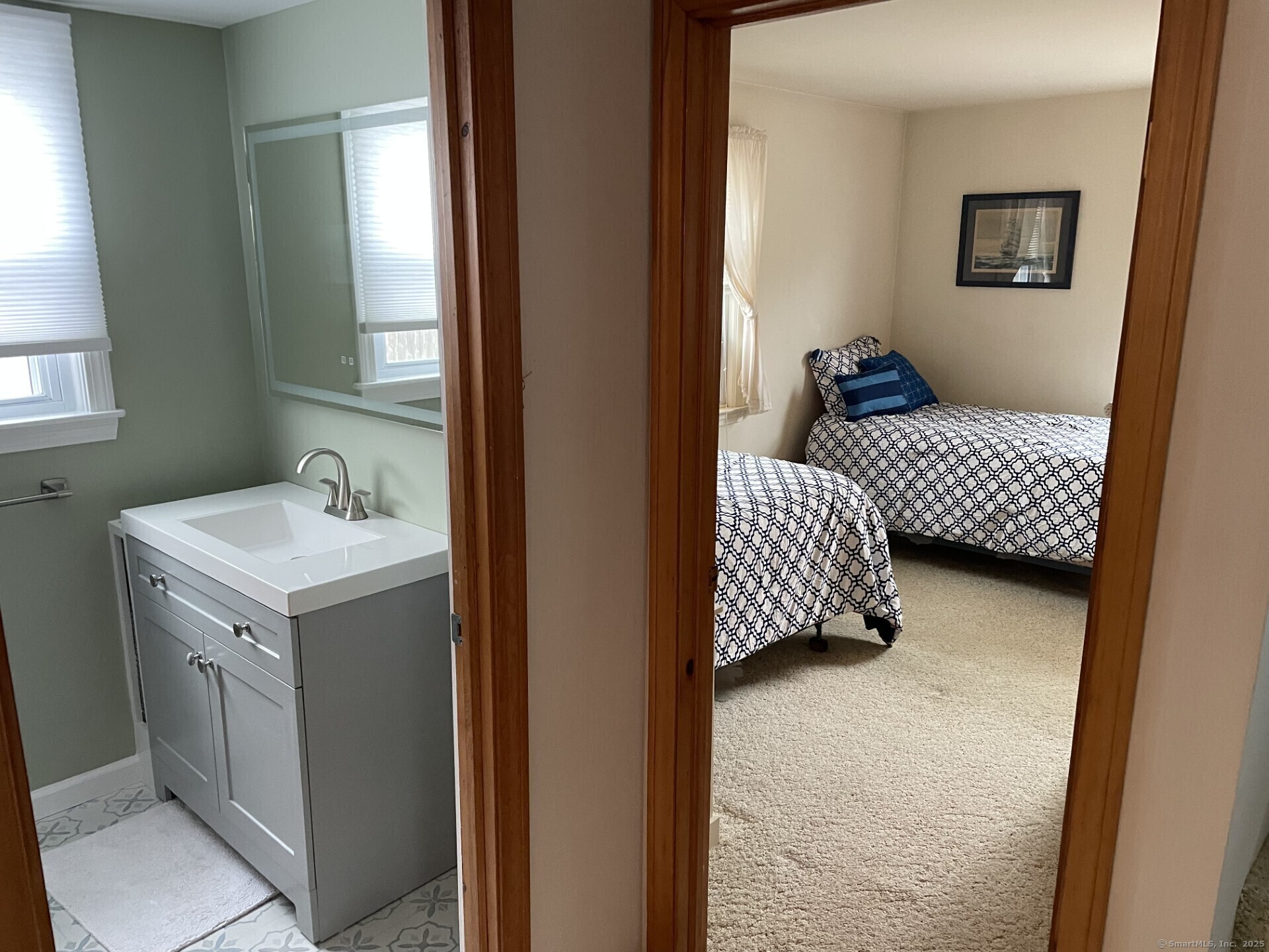 41 Harbor Avenue Madison, CT 06443 - Photo 22 of 27 a en suite bathroom with a sink and mirror