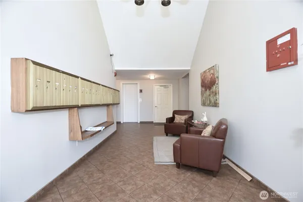 a living room with furniture a fireplace and a floor to ceiling window