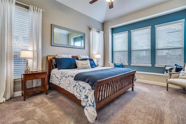 a bed sitting in a bedroom next to a window