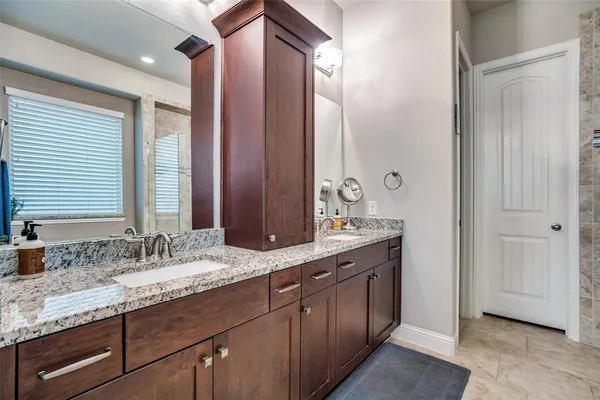a bathroom with a granite countertop sink double and mirror