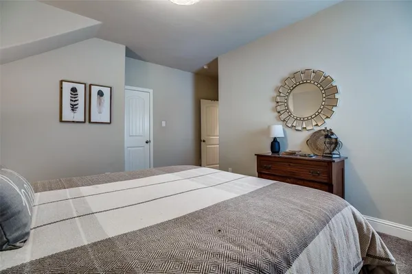 a bedroom with a bed and a mirror