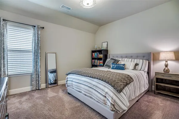 a bedroom with a bed and a night stand