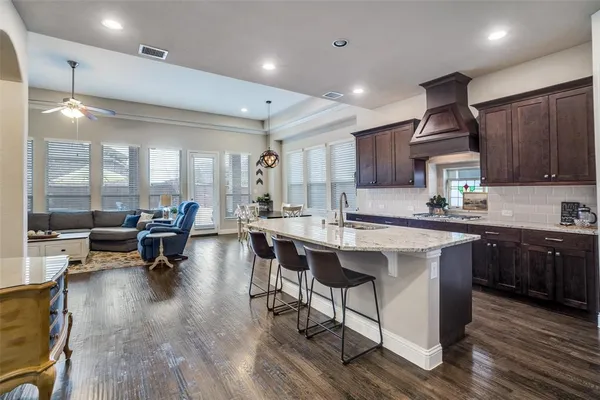 a kitchen with counter space dining table and chairs