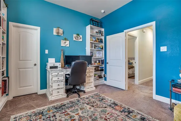 a view of a workspace with furniture and a window