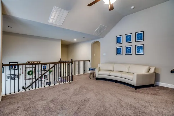 a living room with furniture and a lamp