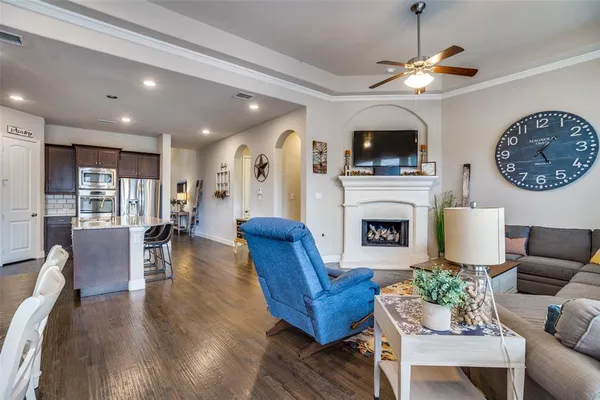 a living room with furniture a flat screen tv and a fireplace