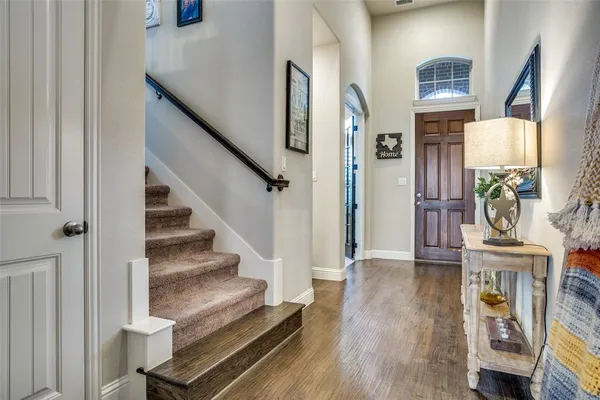 a view of entryway and hall with wooden floor