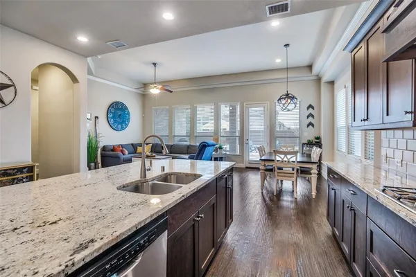 a kitchen with sink stove and view living room